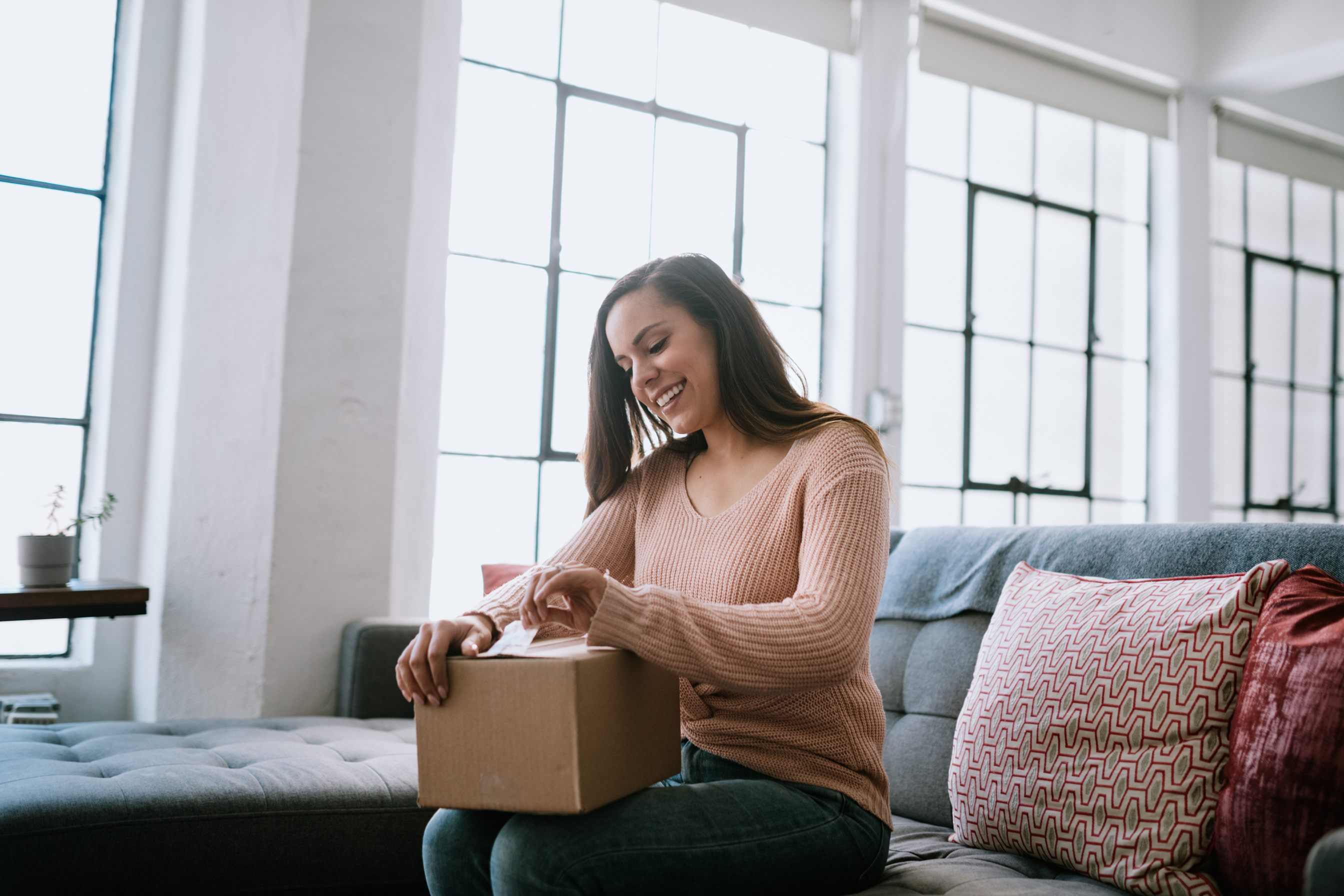 Excited Young Woman Opens Package Delivery