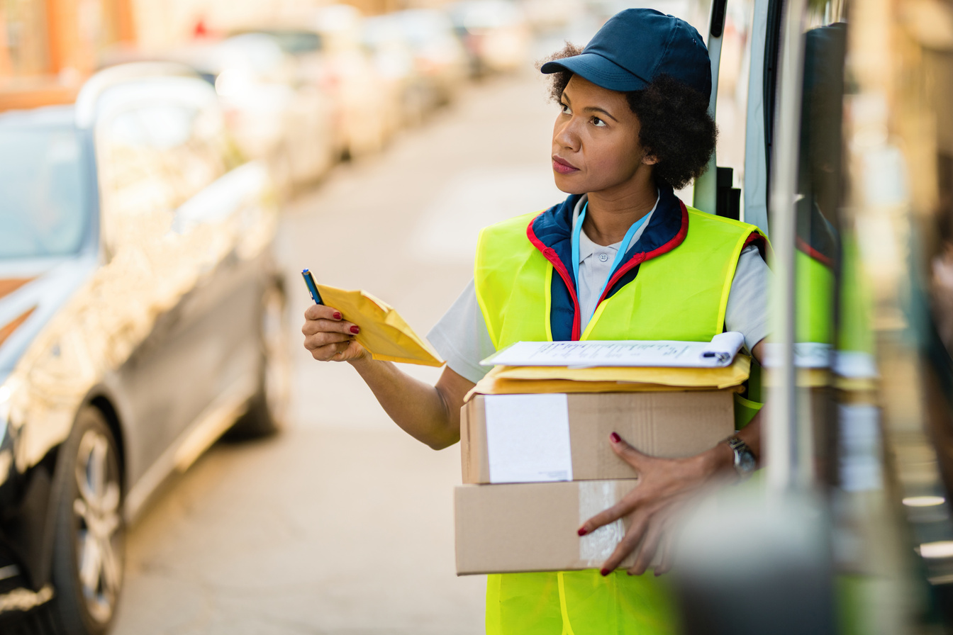 Black female delivery person working in the city.